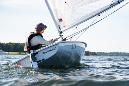 Sailor going downwind in a Zim ILCA dinghy